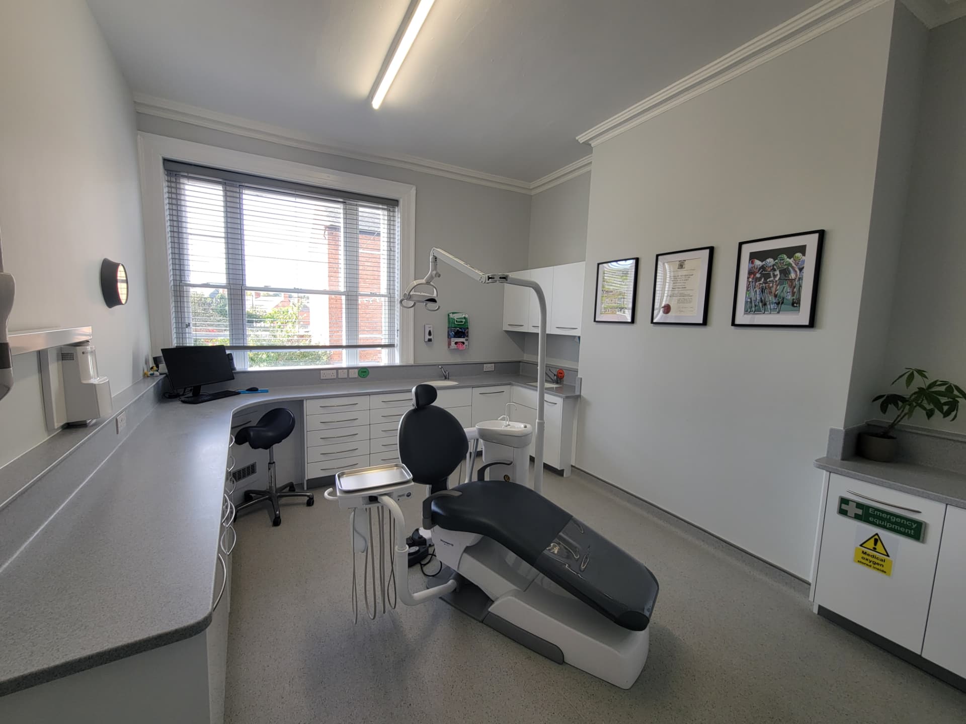 A treatment room at Willow Street Dental, showing the dental chair, counters and a window with blinds